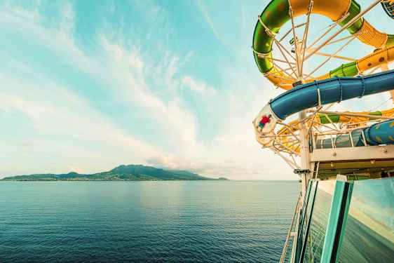 Vattenrutschbana på kryssningsfartyg vid havet, med ö i bakgrunden. (AI-genererad text)