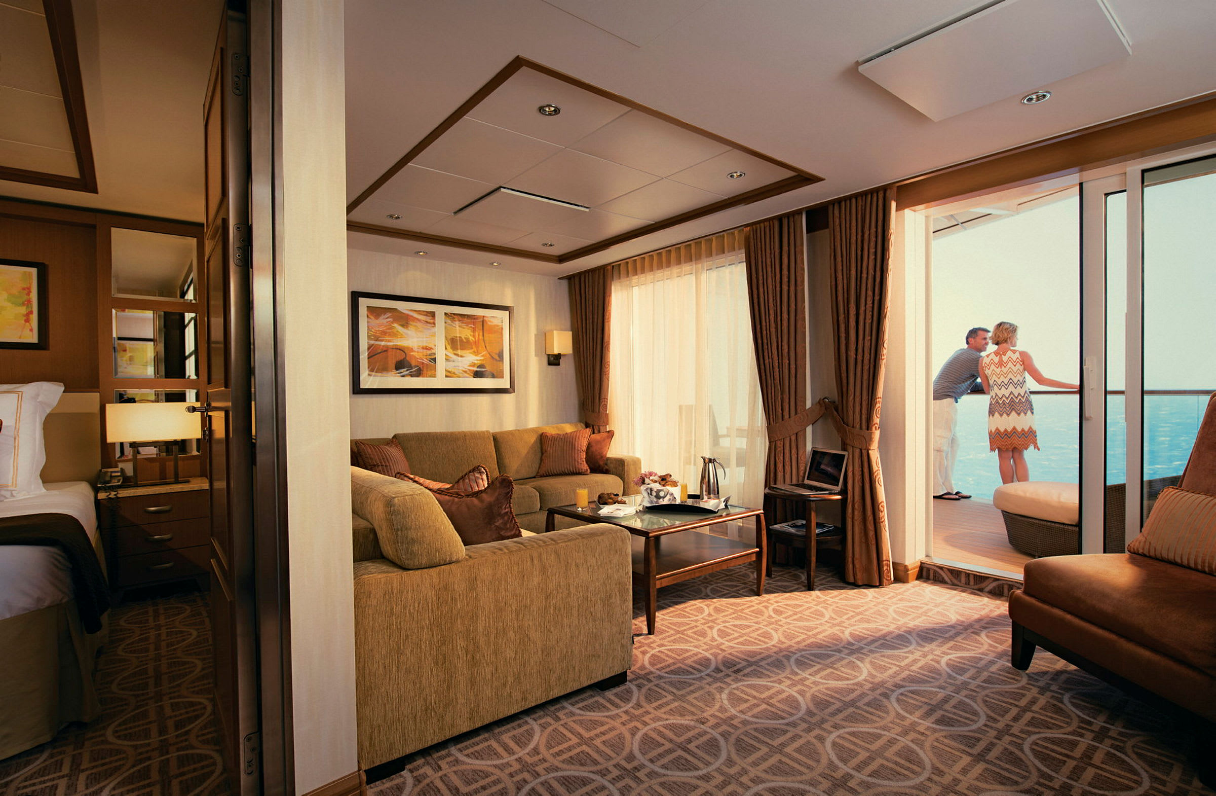 Ett elegant hotellrum med sittmöbler och ett bord, samt en balkong med utsikt över havet. (AI-genererad text)