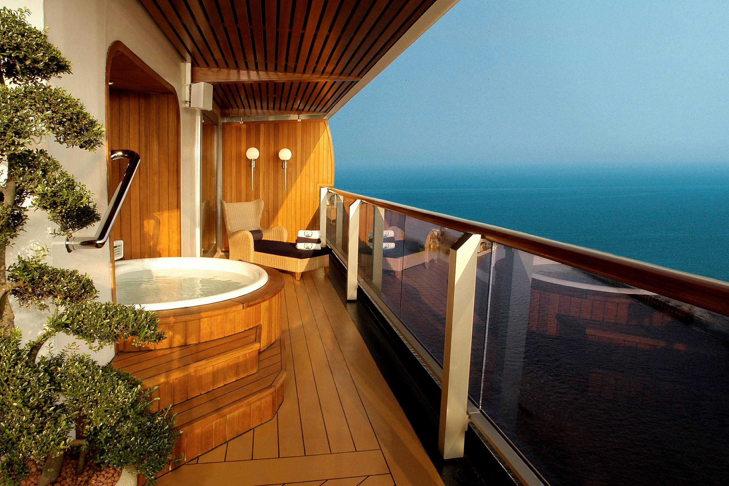 En balkong med en jacuzzi och utsikt över havet. (AI-genererad text)
