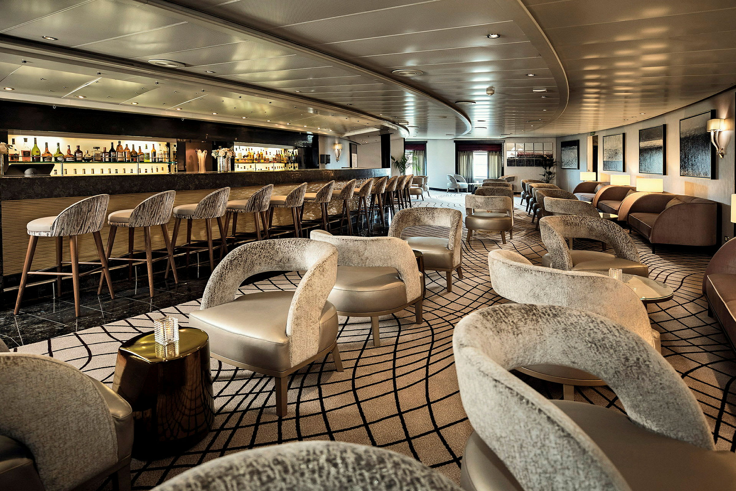 En elegant lounge med fåtöljer och en lång bardisk. (AI-genererad text)