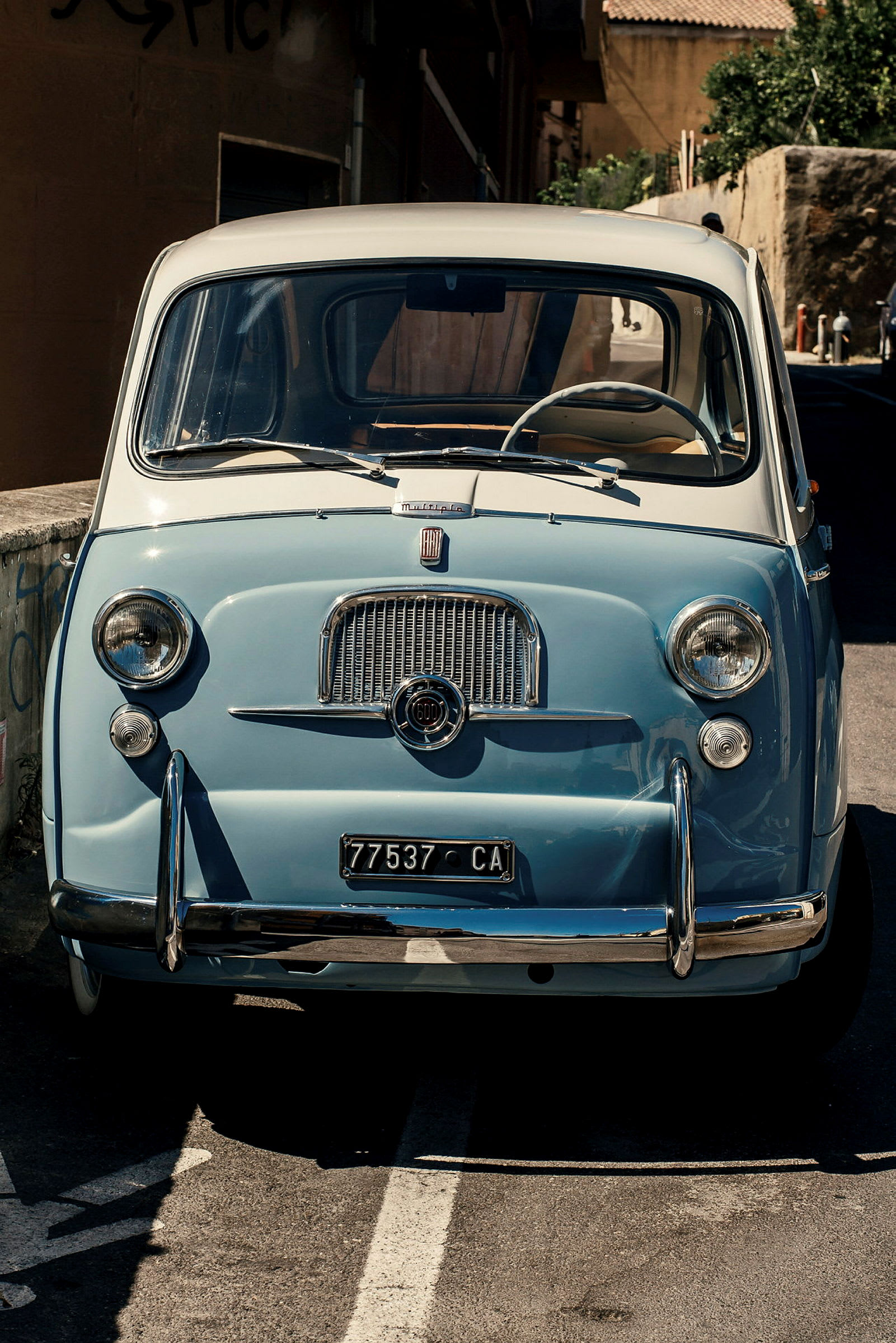 En ljusblå vintagebil, fotograferad framifrån. (AI-genererad text)